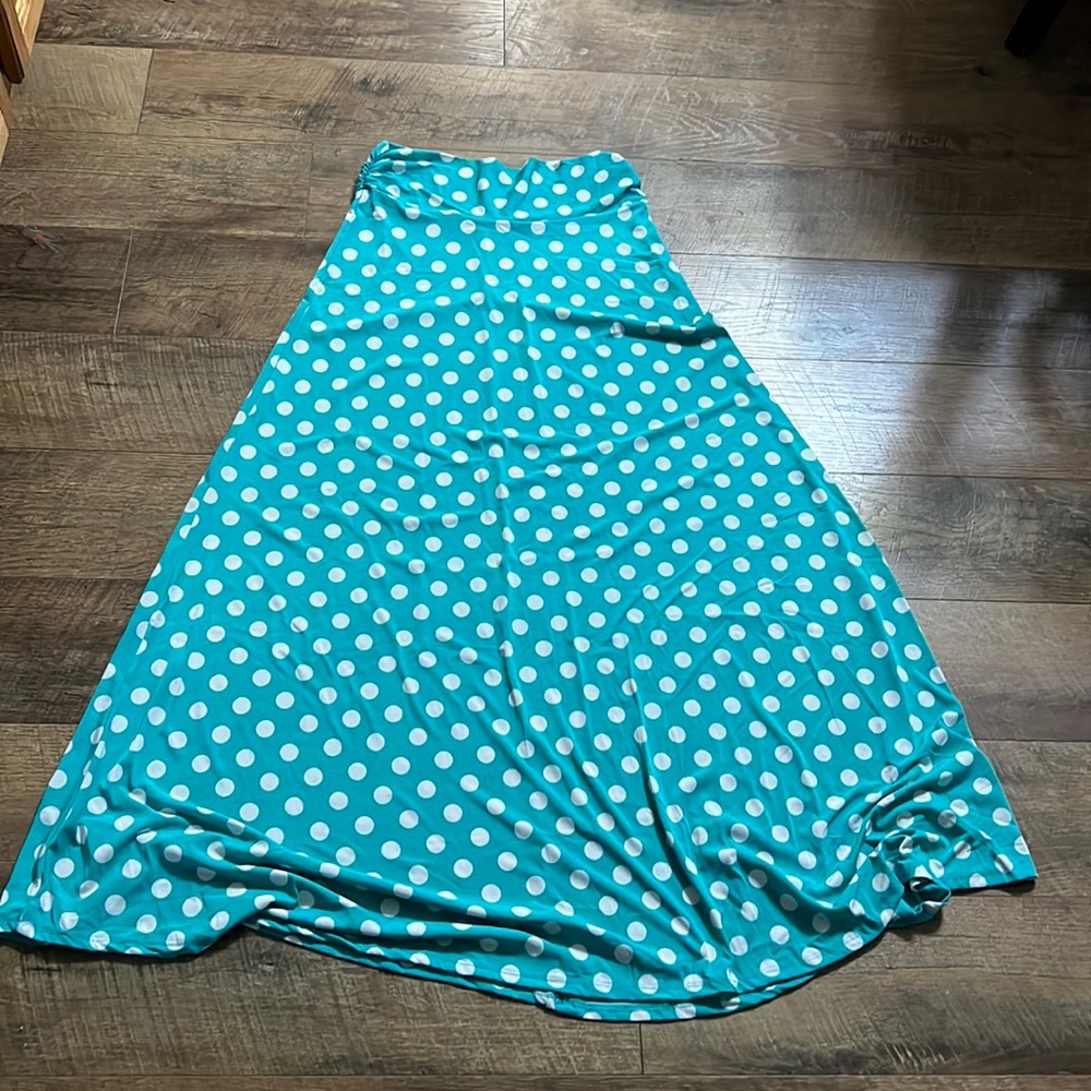 A teal blue, polka dotted max skirt